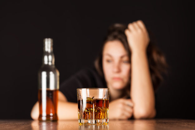 woman looking off into distance after drinking alcohol